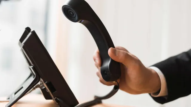 businessman holding headset scaled